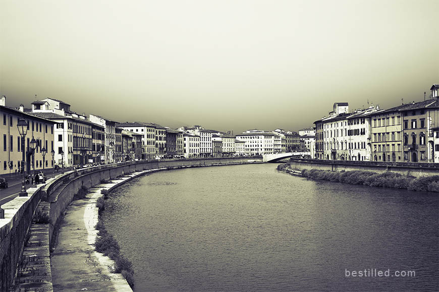 Monochrome art photograph of the Arno river through Pisa, Italy, by Joseph Westrupp.