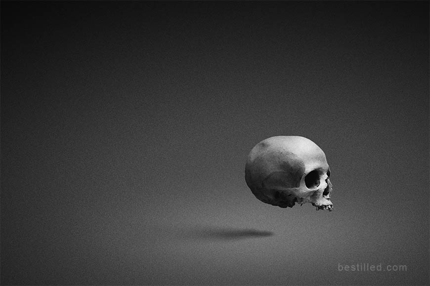 Skull floating in empty space, surreal art in black and white by Joseph Westrupp.