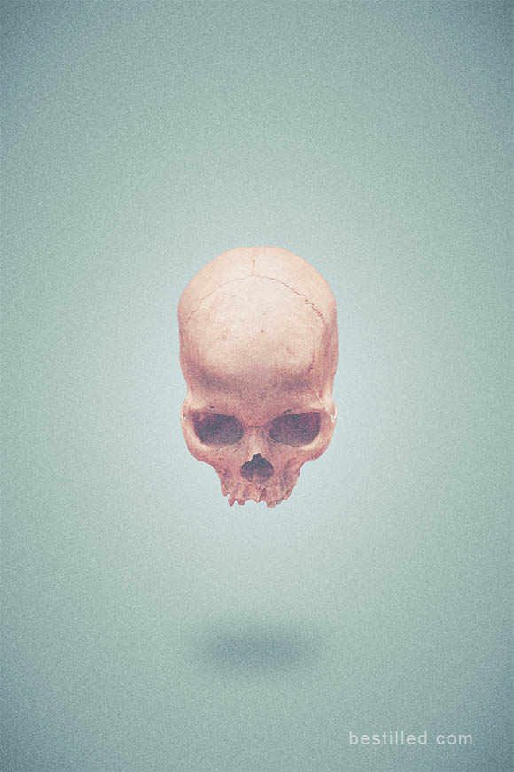 Tan skull floating in bare blue space. Surreal art by Joseph Westrupp.