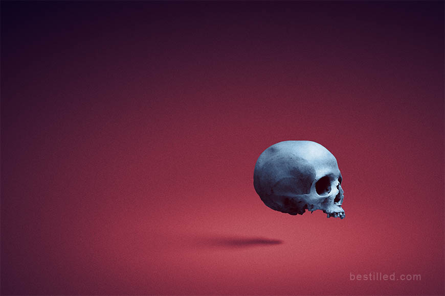 Blue skull floating in empty red space, surreal artwork by Joseph Westrupp.