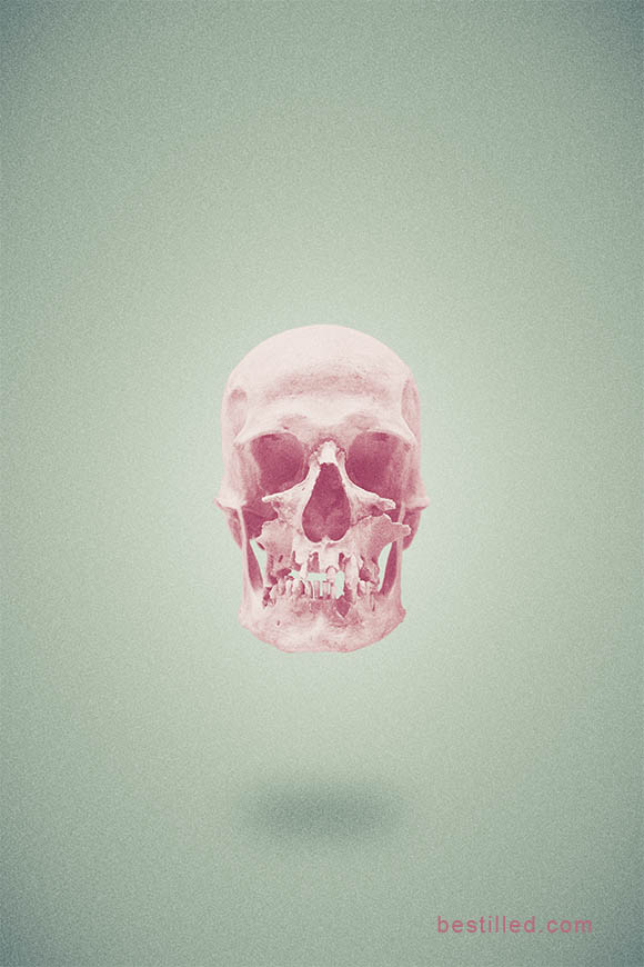 Pink skull floating in bare green space, surreal art by Joseph Westrupp.
