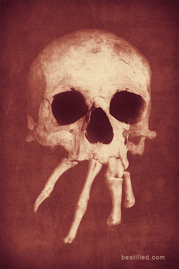 Skull with bones as teeth. Surreal art in red and gold by Joseph Westrupp.