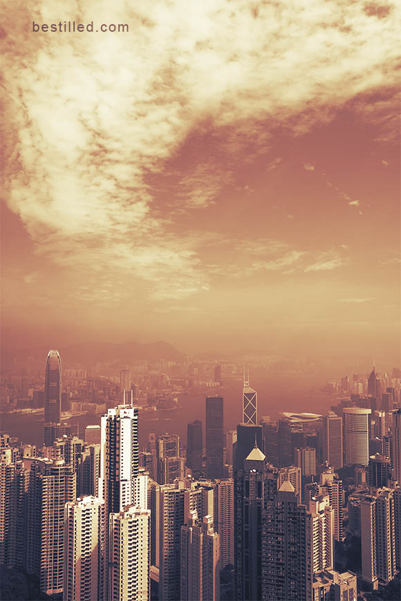 Orange cityscape of Hong Kong beneath dramatic cloud. Art photograph by Joseph Westrupp.