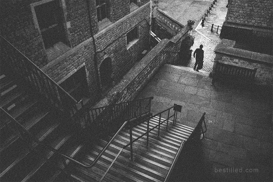 Art photograph of a man descending stairs at the Tower of London, by Joseph Westrupp.