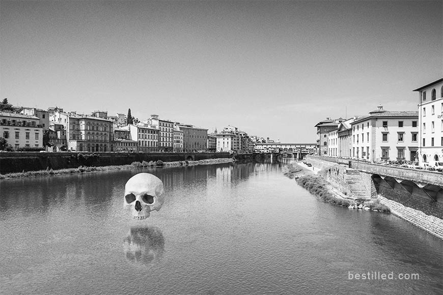 Skull hovering over the Arno river in Florence, Italy. Surreal black and white art photo by Joseph Westrupp.