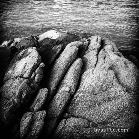Black and white art photo of rocks and ocean on the shoreline of Ko Samet, Thailand. By Joseph Westrupp.