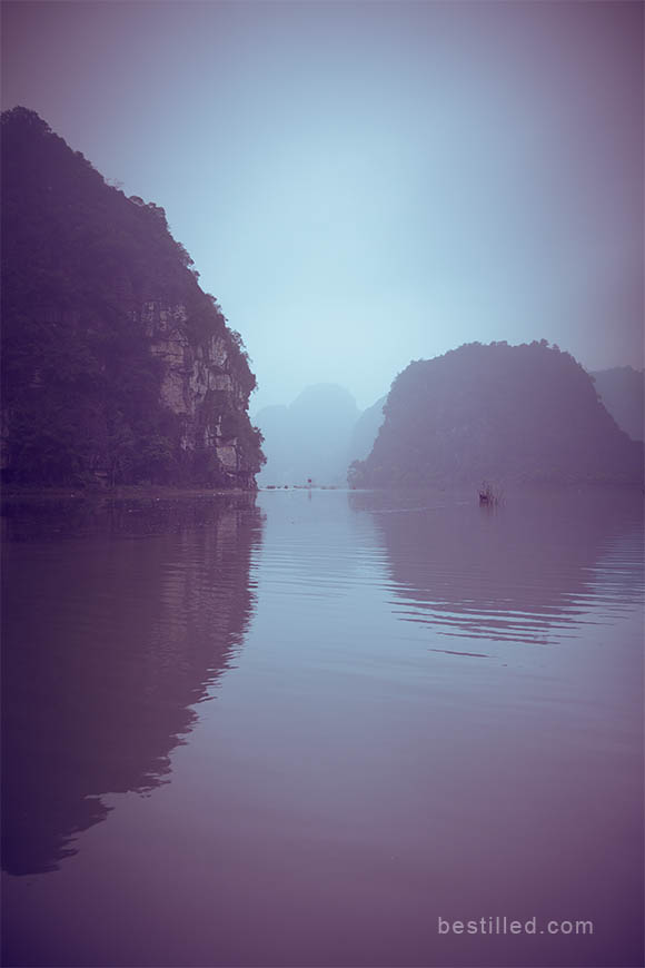 Blue and purple islands in the Ninh Binh river, Vietnam. Art photo by Joseph Westrupp.