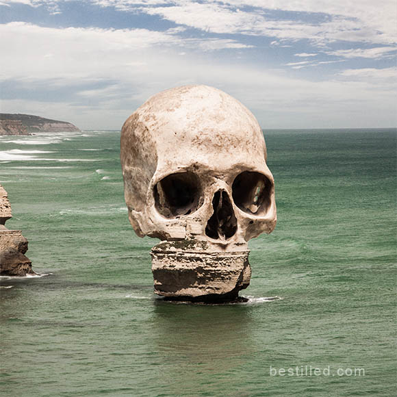 Skull-shaped island in green ocean, surreal artwork by Joseph Westrupp.