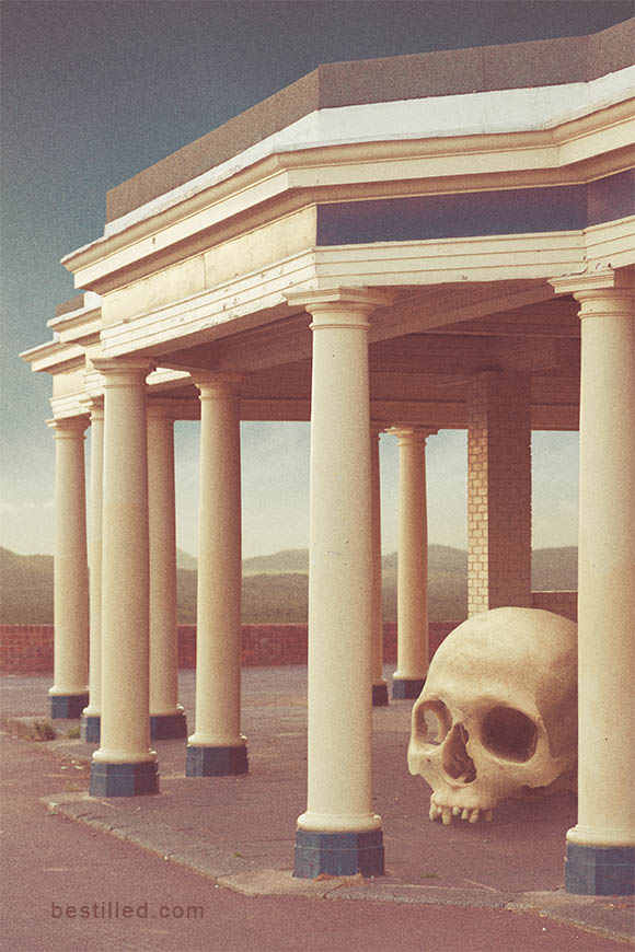 Giant skull in pillared shelter on the bank of the Thames, surreal artwork by Joseph Westrupp.