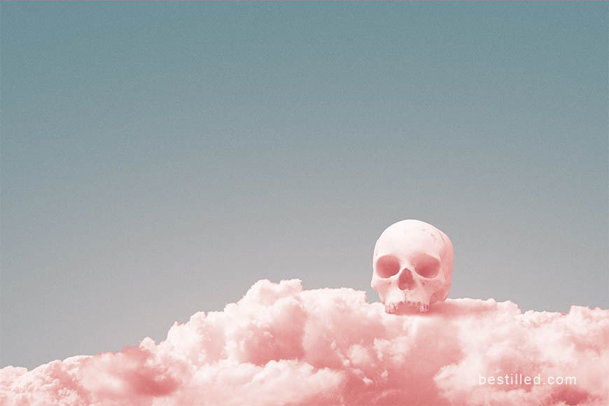 Pink skull sitting on a pink cloud, surreal artwork by Joseph Westrupp.